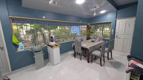 a dining room with a table and chairs at Muraadh Home Stay in Fuvahmulah