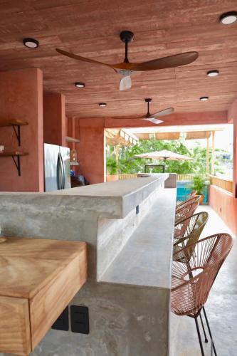 a kitchen with a counter with chairs and a bar at Casa Malagua Hotel Boutique in Puerto Escondido