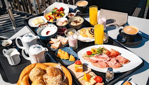 a table with a tray of breakfast food on it at Sonnleiten Sonnenadler 1 in Collepietra