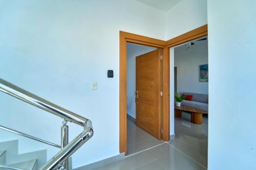 a staircase leading to a room with a door at Cozy Nest in La Romana