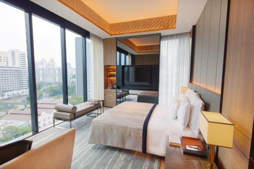 a bedroom with a large bed and a large window at InterContinental Singapore Robertson Quay by IHG in Singapore