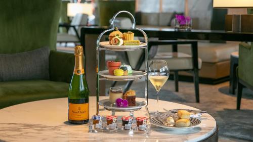 a tray of food and a bottle of wine on a table at InterContinental Singapore Robertson Quay by IHG in Singapore