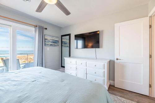 a bedroom with a bed and a view of the ocean at Experience Ocean Views at Pinstripe Paradise, 5 BR, Pool, Pets OK! in Avalon Bench