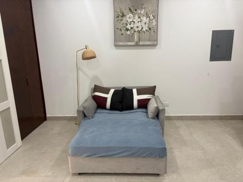 a bed sitting in a living room with at Cabo Manor - Boutique Condo in Cabo San Lucas