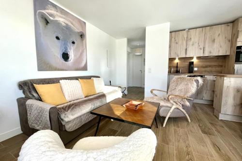 a living room with a couch and a table at Le Balcon des Princesses in Demi-Quartier