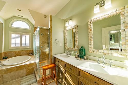 a bathroom with two sinks and a shower at Point of View in Nags Head