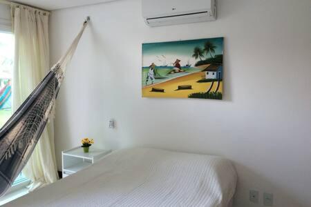 Giường trong phòng chung tại Flat Club Meridional Carneiros