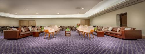 a waiting room with leather couches and tables and chairs at InterContinental São Paulo by IHG in Sao Paulo