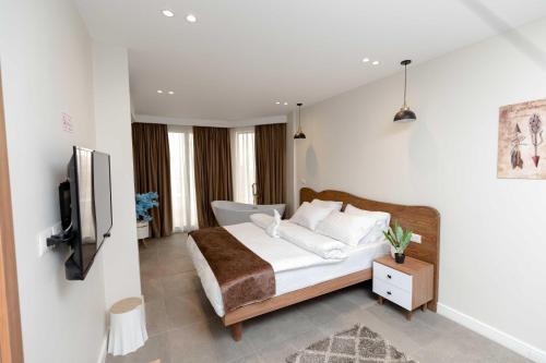 a bedroom with a bed and a television in it at Eyes Of Egypt Pyramids View Boutique Hotel in Cairo