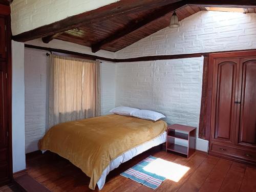 a bedroom with a large bed in a room at Beautiful country house in Latacunga in Pujilí