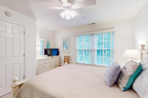 a white bedroom with a bed and a ceiling fan at Bear Trap Dunes - 51 Tulip Poplar in Ocean View