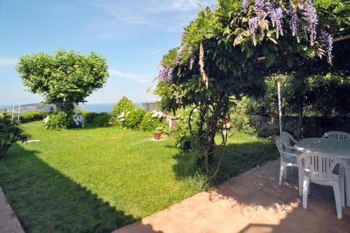 a patio with a table and chairs in a yard at Casa Sayanes in Vigo