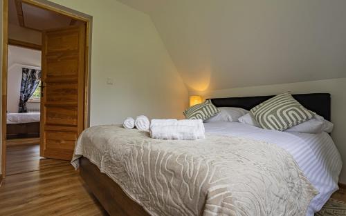 a bedroom with a large bed with towels on it at GLICZAROWA OSADA, Chata 18 osób, Domek 8 osób NA WYŁĄCZNOŚĆ, 8 sypialni z łazienkami, spokój, przyroda, wyjątkowe miejsce in Gliczarów