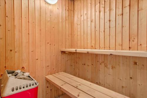 a sauna with a bench and a stove in it at TV1170-Jerup-Engblommen-7 in Jerup