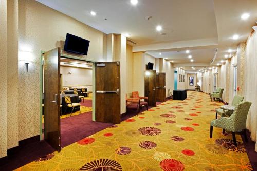 a hotel room with a lobby with a hallway with a waiting room at Holiday Inn Rock Hill by IHG in Rock Hill
