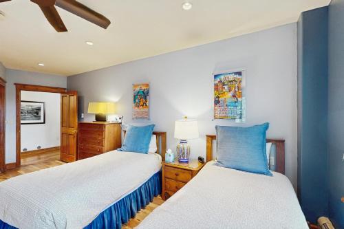 two beds in a bedroom with blue and white at Palmyra 4A - Panoramic Peaks Lodge in Telluride