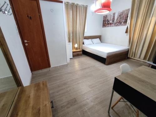 a small room with a bed and a table at Beach Inn TLV Center in Tel Aviv