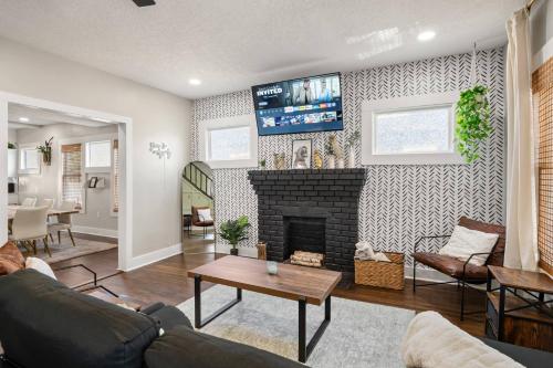 a living room with a fireplace and a tv at Historic 4BR Home centrally located in Riverside. in Jacksonville