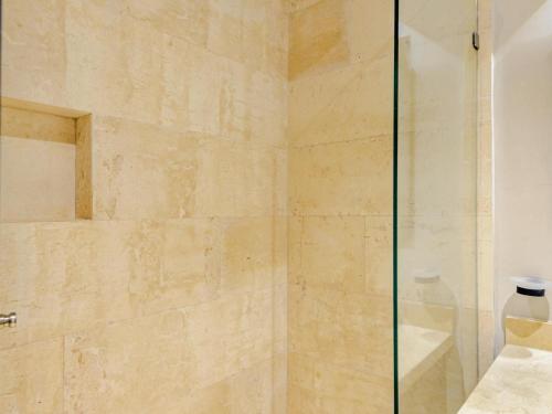 a shower with a glass door in a bathroom at Tulum City Apartments Bakal C in Tulum