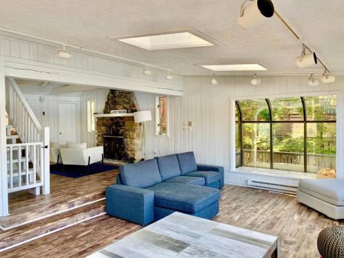 a living room with a blue couch and a table at Dream Lakefront Escape + Beach/Ski/Golf near NYC in Highland Lakes