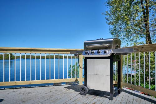 a grill on a deck next to the water at Dream Lakefront Escape + Beach/Ski/Golf near NYC in Highland Lakes