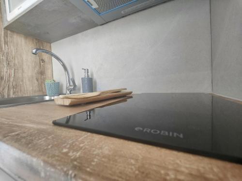a kitchen counter with a laptop on top of it at Corfu Port Studios in Mantoúkion