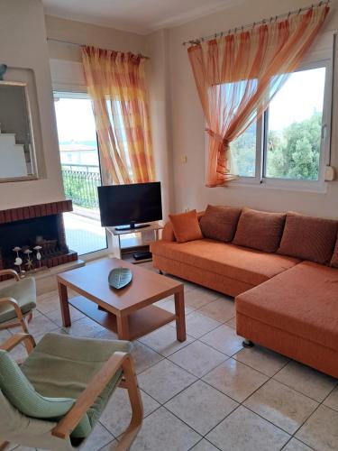a living room with a couch and a table at E&M See View in Polykhrono