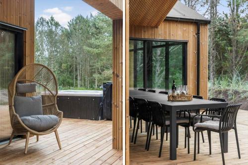a dining room table and chairs on a deck at TV1572-Albaek-Lovevej-18 in Ålbæk