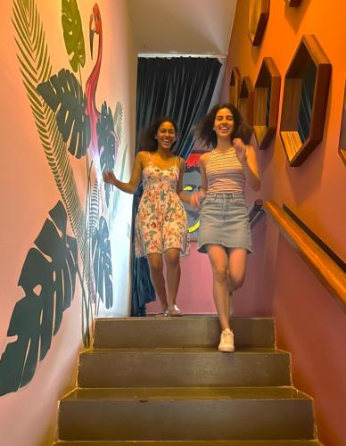 two women walking up the stairs in a house at Casa Chukum - Hotel Boutique in Bacalar