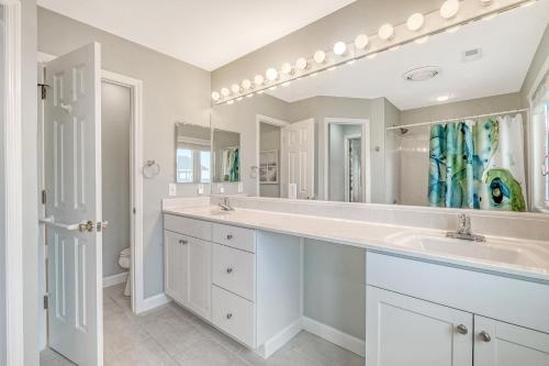 a bathroom with two sinks and a large mirror at 1709 E Ashley Bacon in the sun in Folly Beach