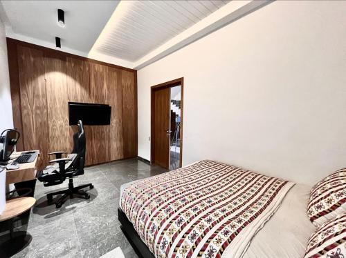 a bedroom with a bed and a desk and a computer at Villa Elia Luxury Oasis in Marrakech