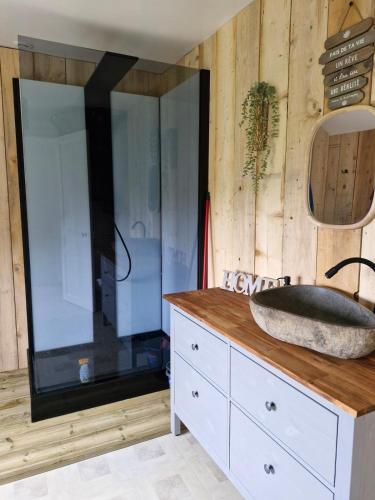 a bathroom with a sink on top of a dresser at Logement cosy Le Margant pour 4 personnes in Guny