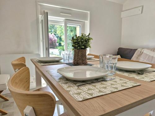 a dining room table with a plate on top of it at Logement cosy Le Margant pour 4 personnes in Guny