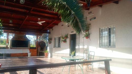 a patio with a table and chairs in a building at Casa Los Frutales in Tafí Viejo