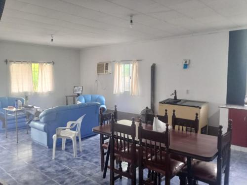 a living room with a couch and a table and chairs at Casa Los Frutales in Tafí Viejo