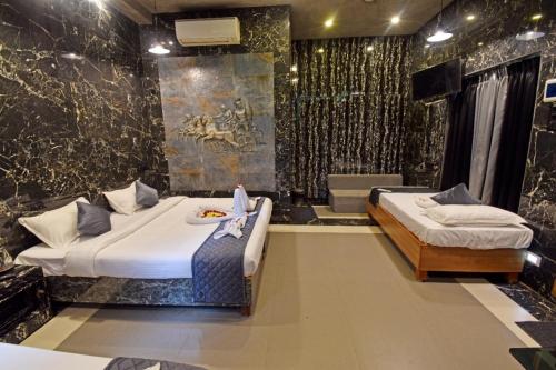 a hotel room with two beds and a bathroom at Aurobay Resorts Pondicherry in Auroville