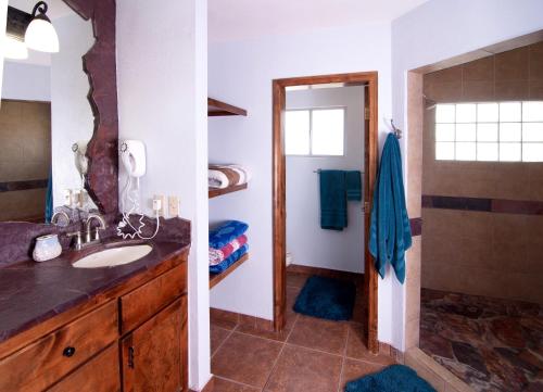 a bathroom with a sink and a shower at Playa Vida in Puerto Peñasco