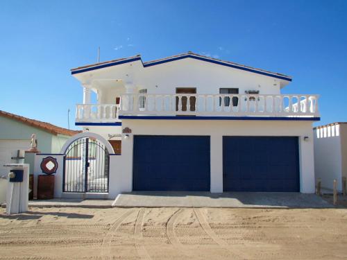 a large white house with a large garage at Playa Encanto Scenic Gem Ocean Front Home in Playa Encanto