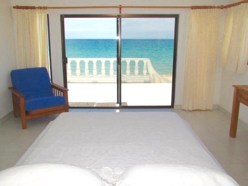 a bedroom with a bed and a view of the ocean at Playa Encanto Scenic Gem Ocean Front Home in Playa Encanto