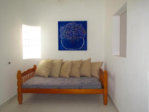a wooden bench in a room with a blue painting at Playa Encanto Scenic Gem Ocean Front Home in Playa Encanto