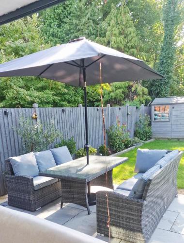 a table with an umbrella on a patio at The Dorking Hideaway in Dorking