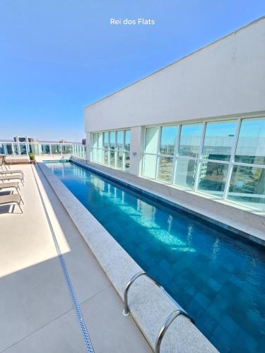 a swimming pool in front of a building at Flat Saint Moritz Express By Rei dos Flats in Brasilia