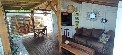 a living room with a couch and a table at Kaz'bouchons in Saint-François