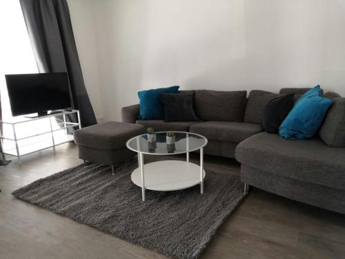 a living room with a couch and a table at Central Apartment for 3 with Sauna in Kittilä
