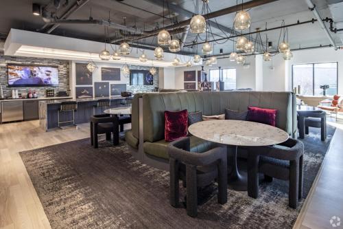 a lobby with couches and tables and a bar at Upscale 2BR Near Regions Field n Park in Birmingham