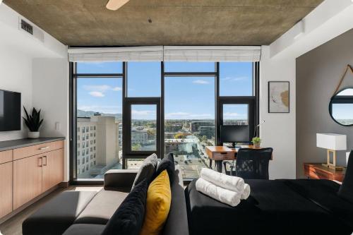 a living room with a couch and a large window at Bright n Airy Studio Perfect City Escape 9 in Birmingham