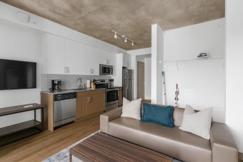 a living room with a couch and a kitchen at Cozy Murphy Hideaway Studio 13th in Birmingham