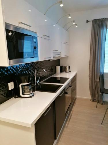 a kitchen with a sink and a counter top at Central Apartment for 2 with Sauna in Kittilä