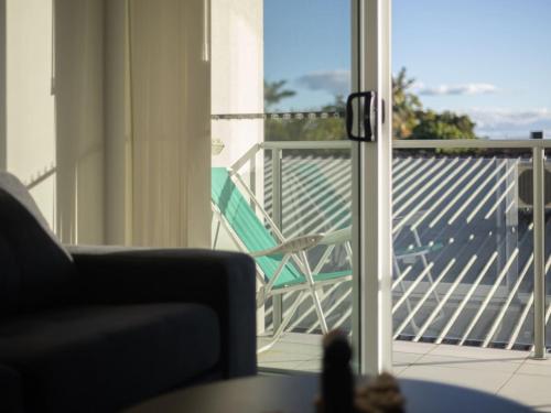 a living room with a chair on a balcony at Cozy 1BR Unit in Springwood Great Location Parking in Springwood
