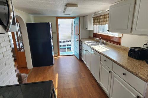 a kitchen with white cabinets and a blue refrigerator at Little Miss Cottages - 5 Seaview House in Old Orchard Beach